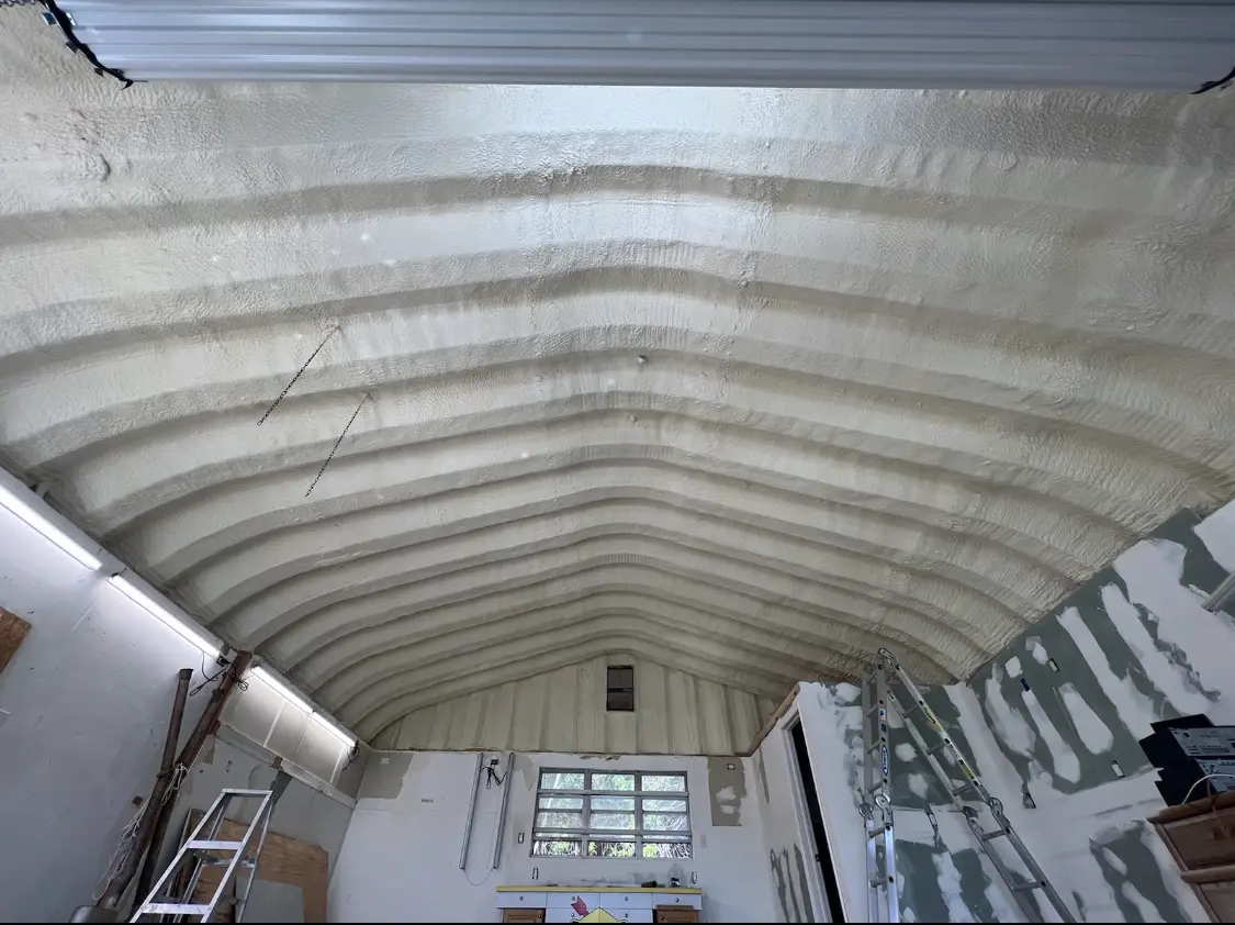Spray polyurethane foam applied to the underside of a metal roof deck in Topsham